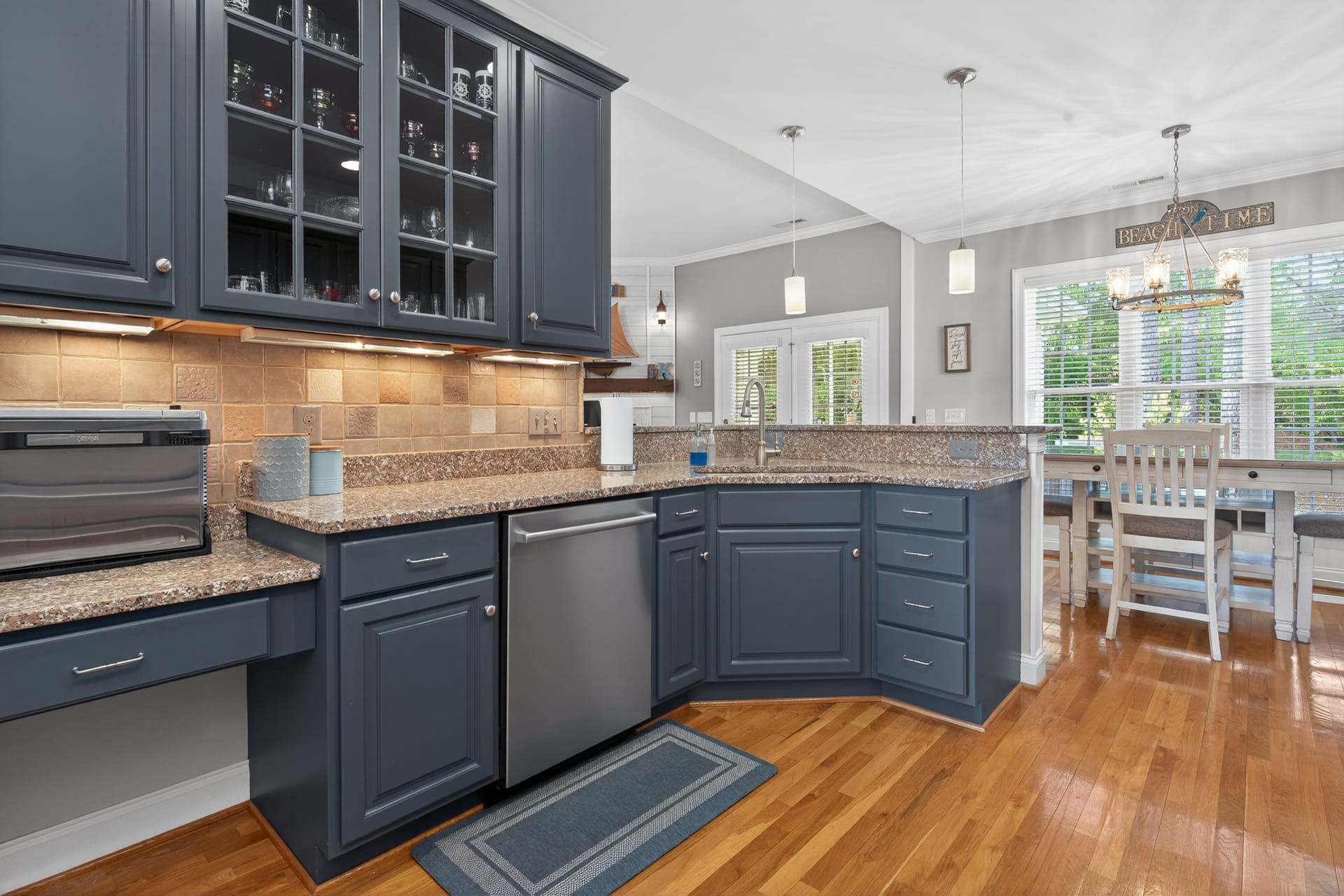 Kitchen with navy cabinets and dining nook