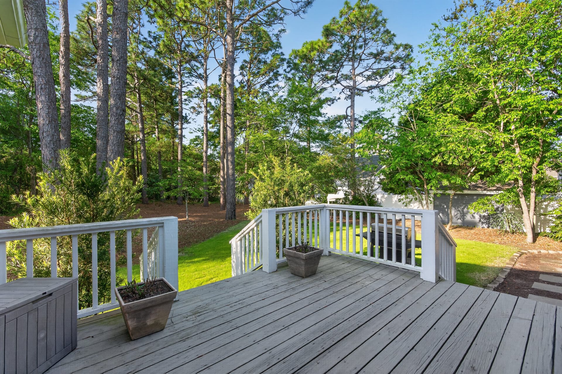 Rear deck with wooded backdrop