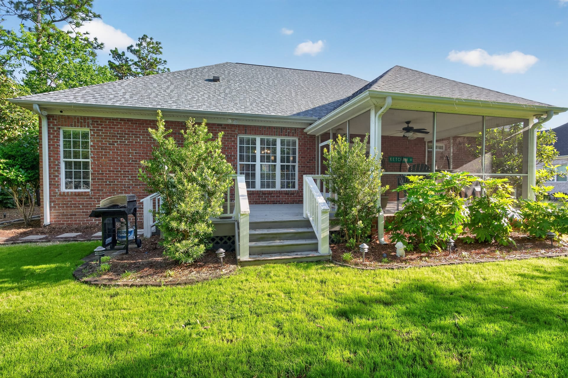 Rear exterior with screened porch and landscaping