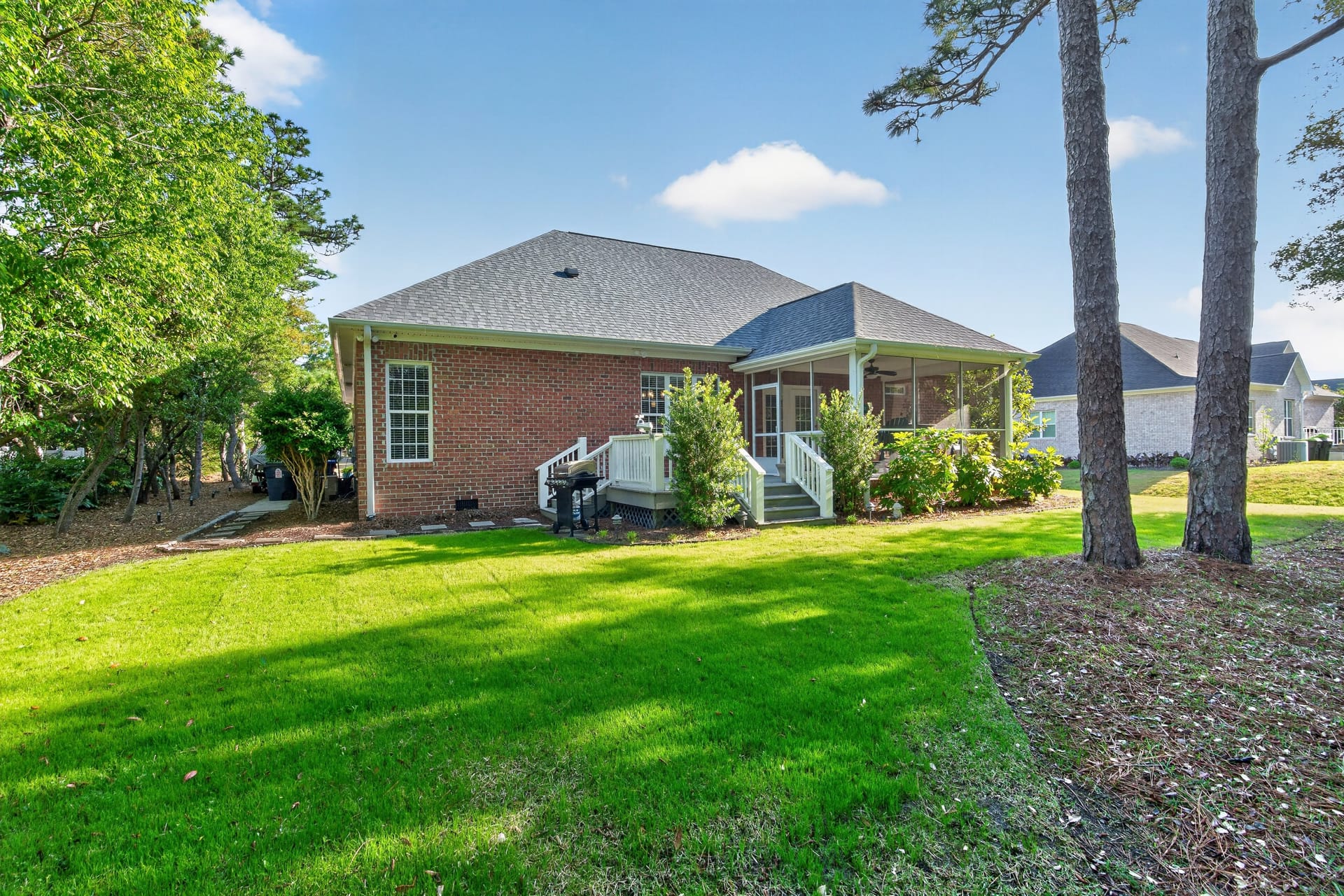 Backyard exterior showing brick home